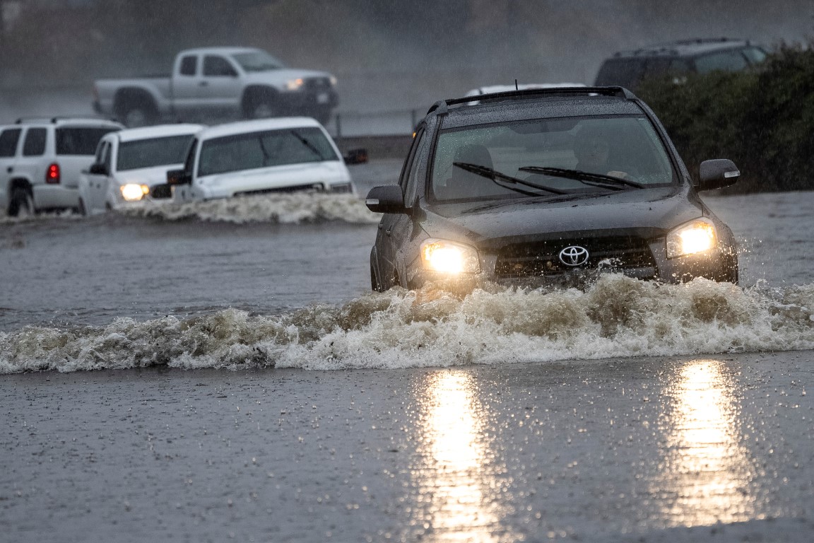 Vehicles drive through a flooded area in Fairfield, California. Photo: Reuters