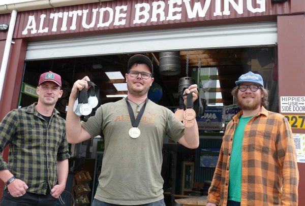Altitude Brewery Co head brewer Eliott Menzies shows off the brewery's medal haul from last week's Brewers Guild of NZ Beer Awards '21 with general manager Peter Forde, left, and managing director Eddie Gapper.