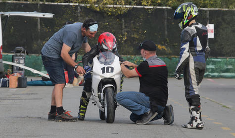 Bede Cordes (left) steadies the Kayo MiniGP bike, Motorcycling Canterbury rider trainer Shannon...