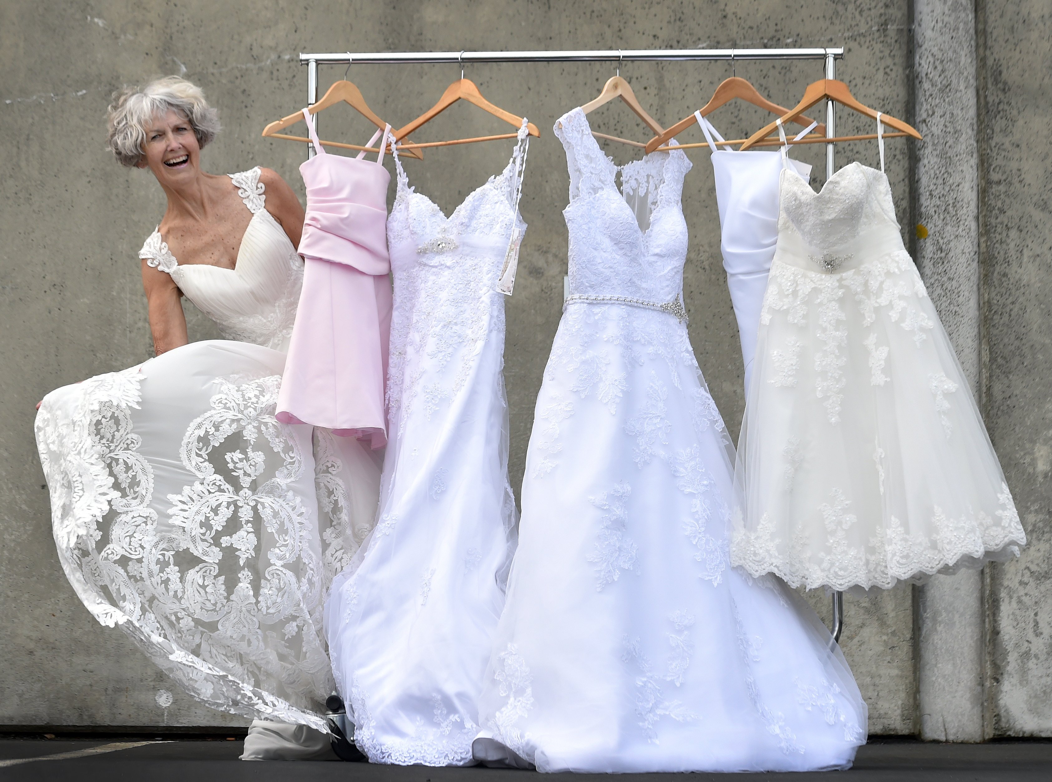 St John Dunedin Store staff member Pauline Bell models one of the brand-new wedding dresses which...