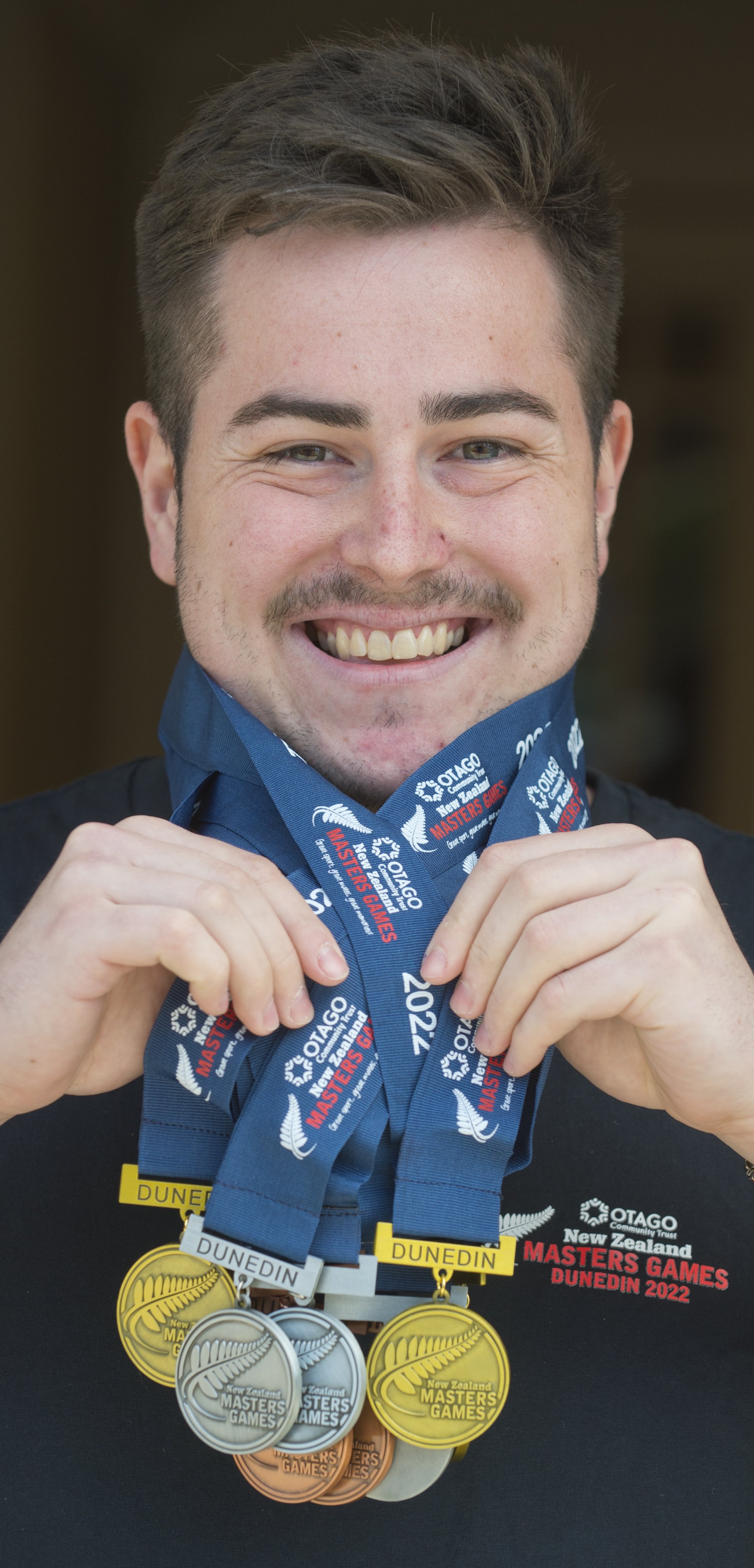 New Zealand Masters Games marketing events assistant Ben Anngow shows off medals produced for...