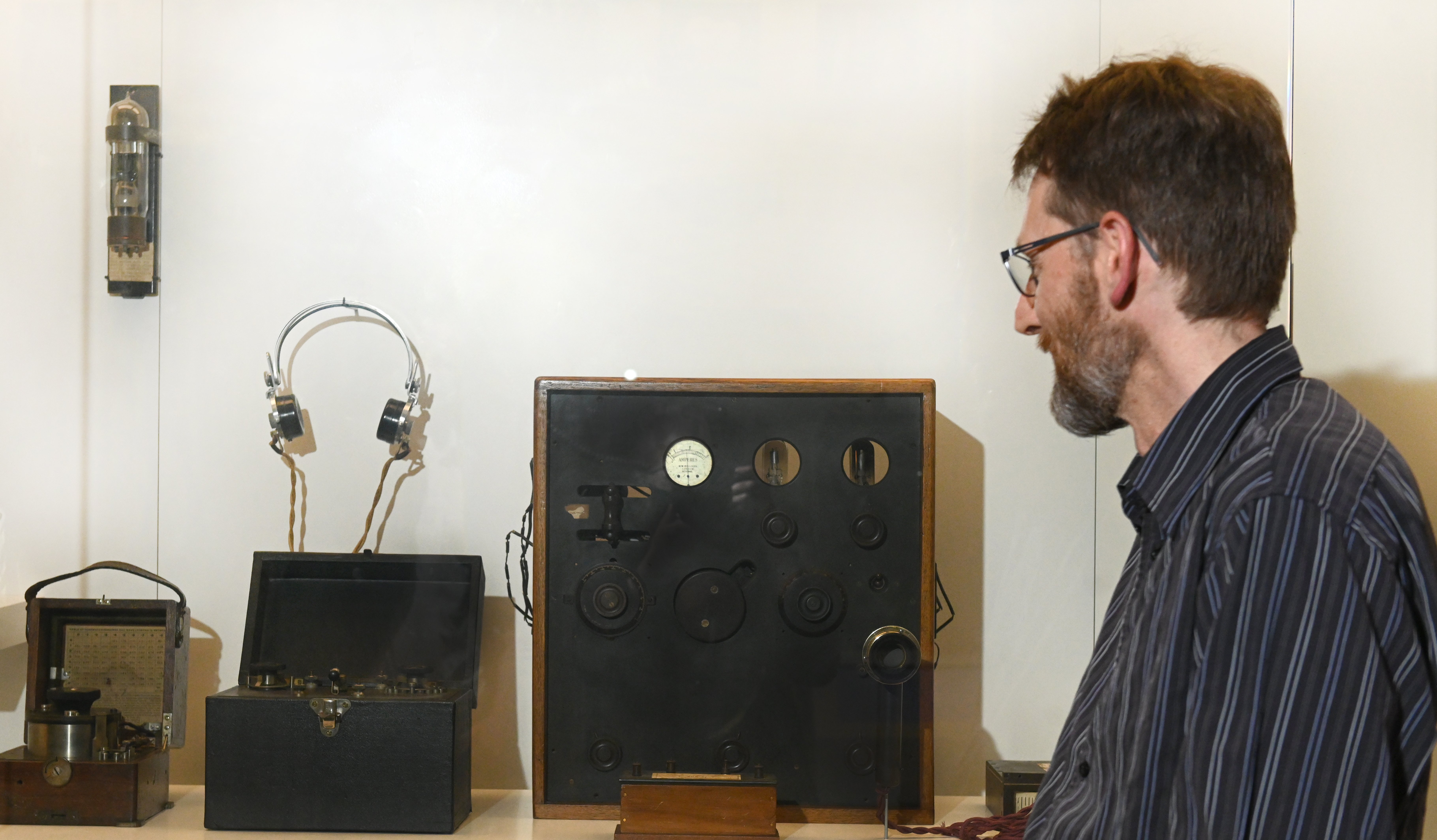 Standing alongside the radio transmitter used in New Zealand’s first voice and music radio...