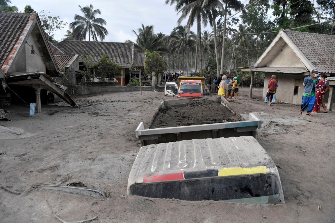 Trucks covered by ash from the eruption in the village of Sumber Wuluh, East Java province. Photo...