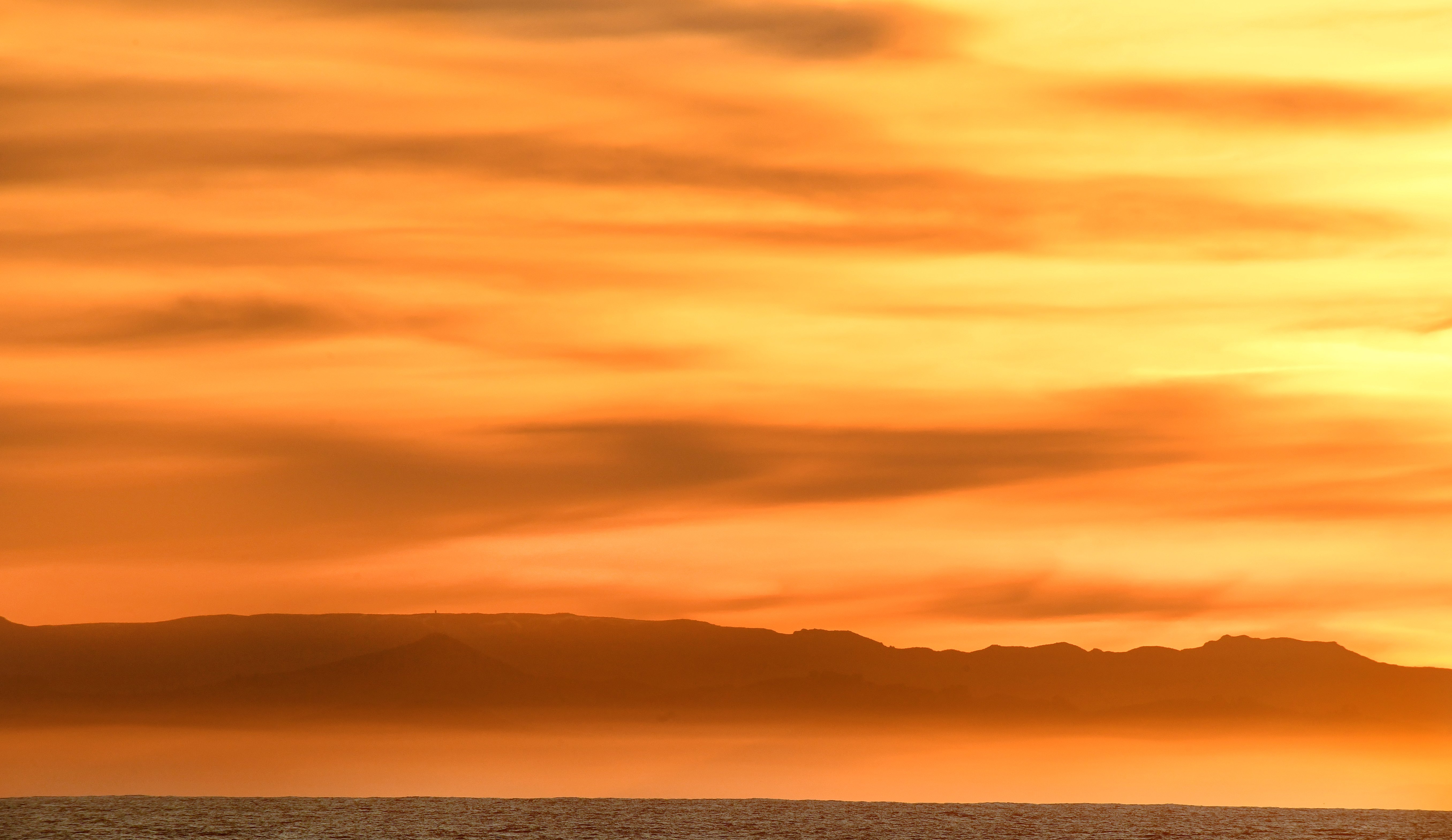 The setting sun colours the western sky over the Otago Peninsula and towards Mt Cargill. Photo: Stephen Jaquiery