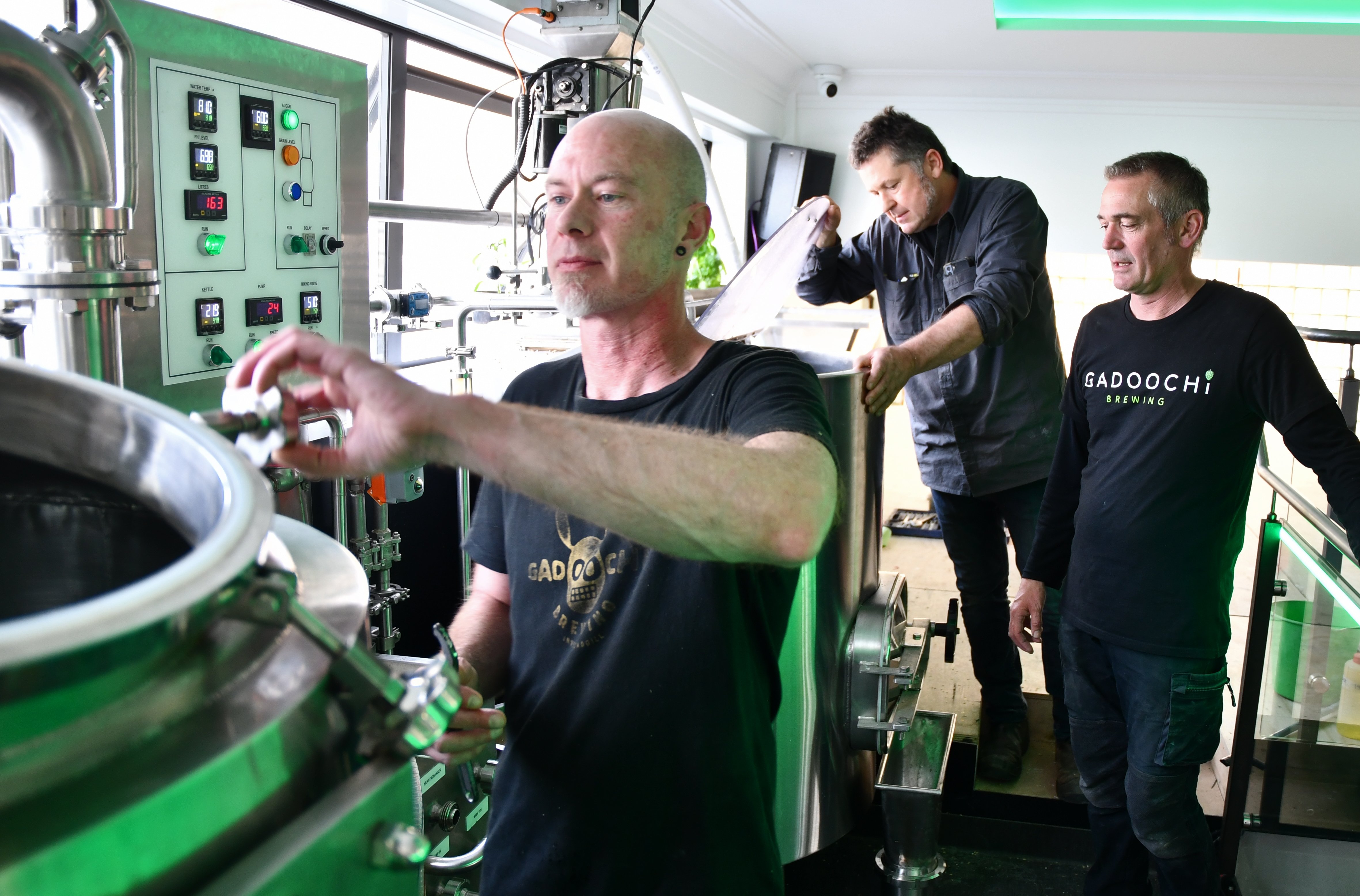 Brewers (from left) Damon Milne, Chris Ellenden and Kelly Robertson at work brewing the first...