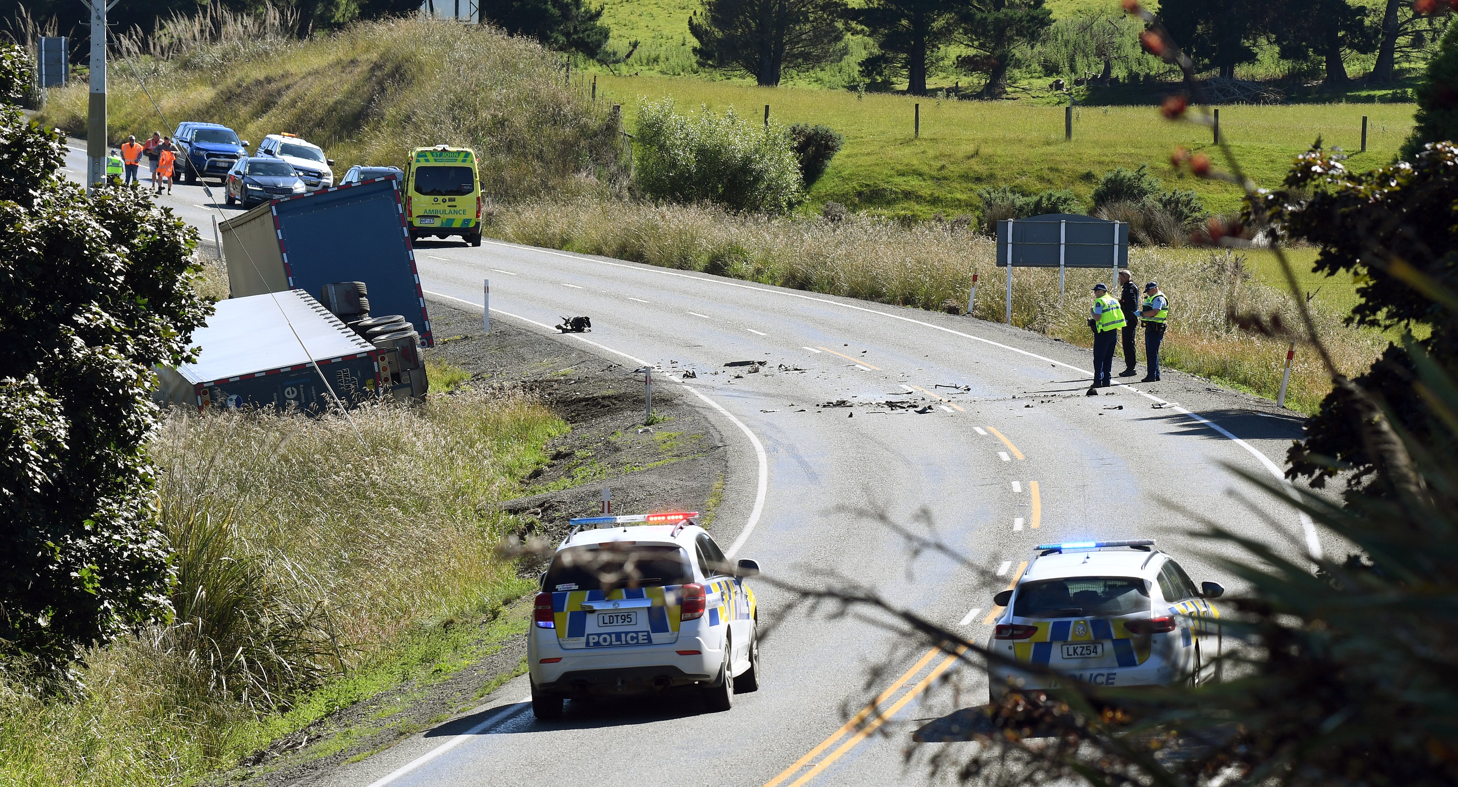 Debris marks the site of a fatal collision between a truck and a car, north of Waihola on...