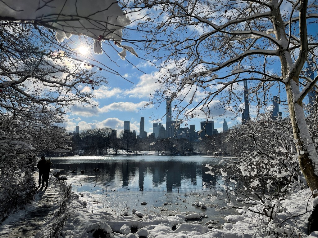 People walk in New York's Central Park after a winter storm dropped several inches of snow on the...