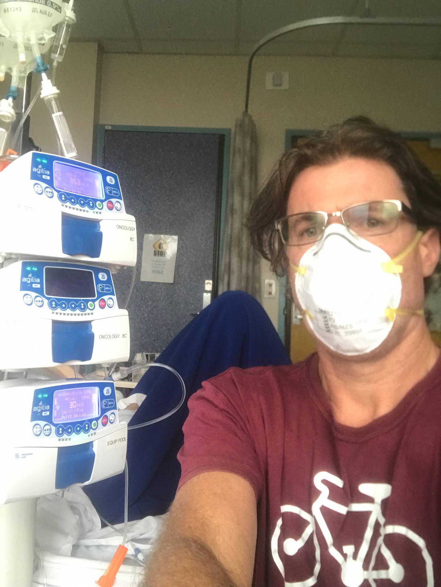 Kypros Kypri at his son's bedside in Dunedin Hospital. Photo: Supplied
