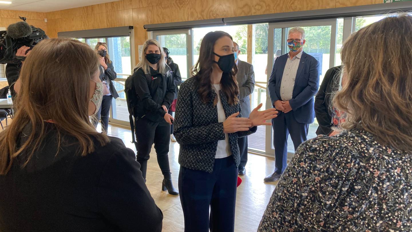 Prime Minister Jacinda Ardern chats with local health workers at a pop-up vaccination clinic at...