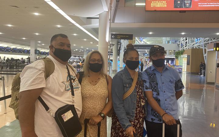 A family awaits the first flight to the Cook Islands at Auckland Airport. Photo: RNZ 

