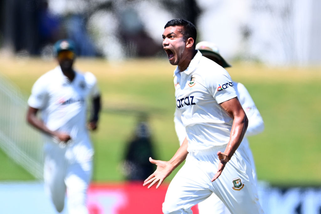 Bangladesh bowler Taskin Ahmed celebrates taking the wicket of New Zealand's Rachin Ravindra...