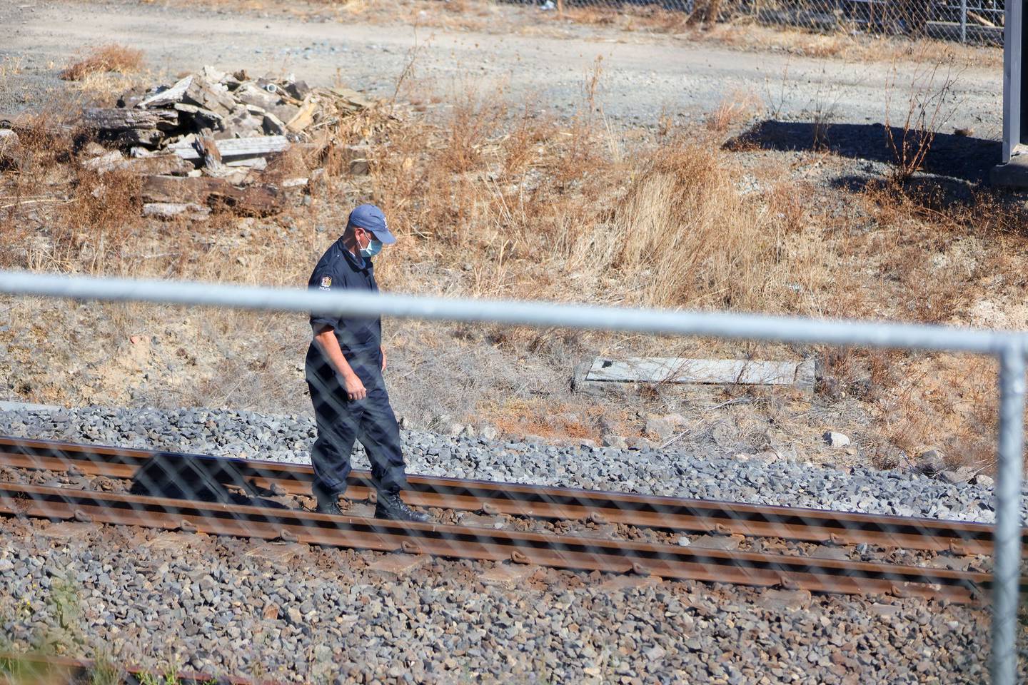 A officer inspects the tracks at Frankton Station this morning. Photo: Mike Scott