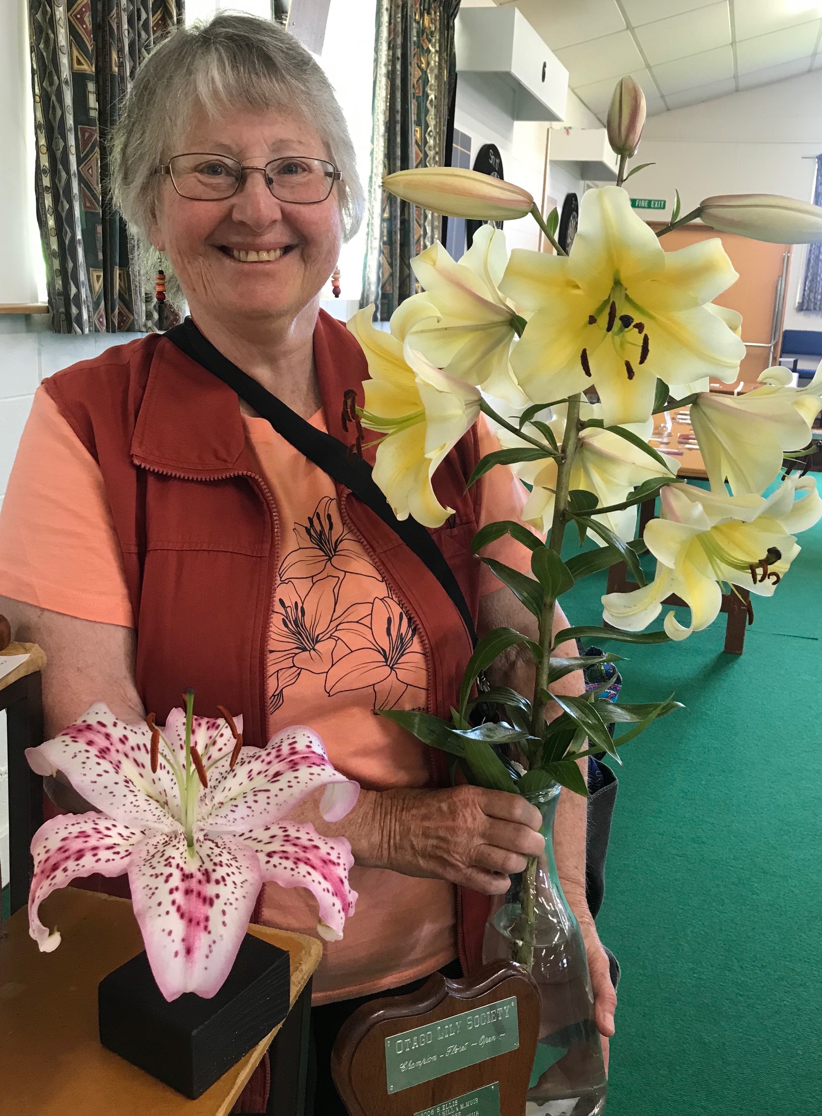 Keri Smith holds two of her prizewinning blooms, a Conca d’Or stem and single bloom Solution at...