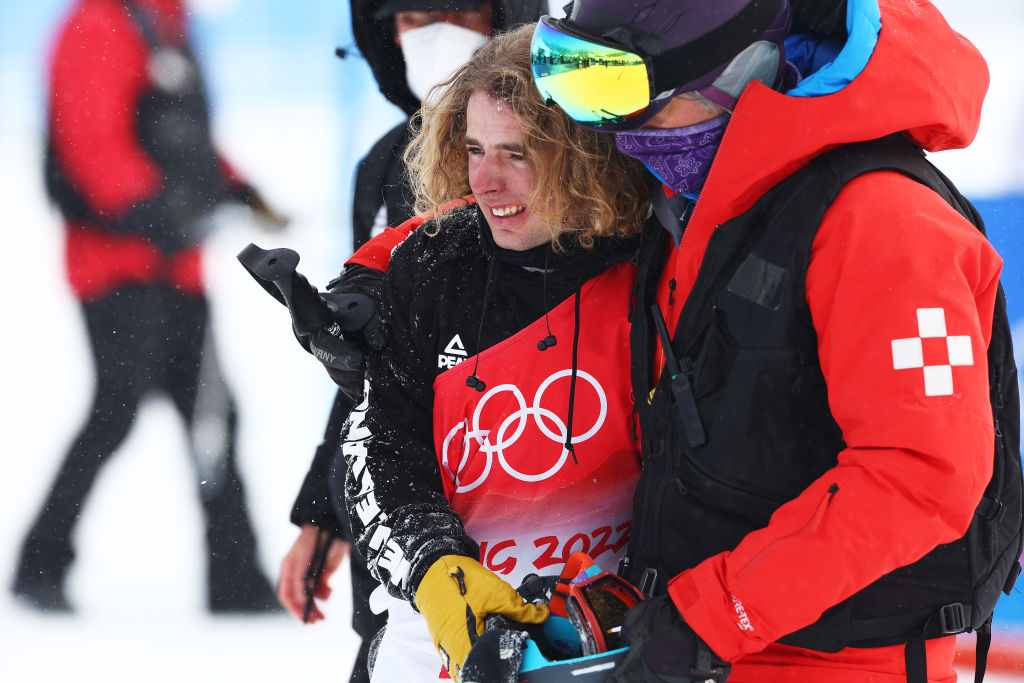 Ben Harrington reacts after crashing while being assisted by medical staff on their second run during the Men's Freestyle Skiing Freeski Halfpipe Qualification. Photo: Getty Images