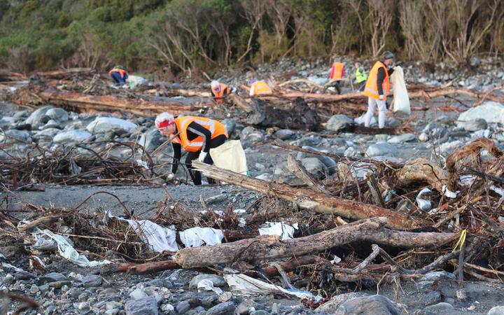 Volunteers pick up rubbish where a disused Fox River landfill spilled litter on the West Coast....
