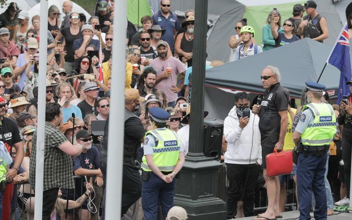 Protesters watched by police in Wellington. Photo: RNZ