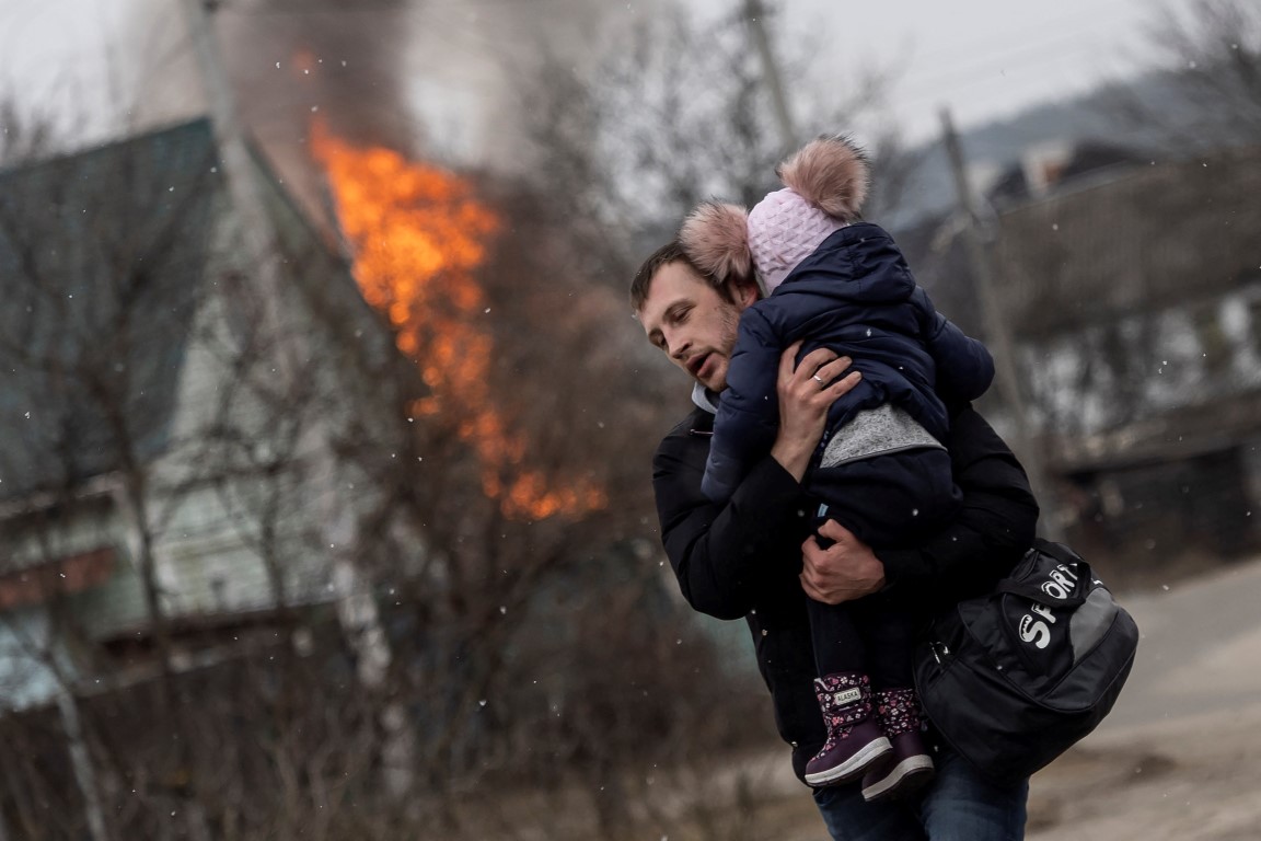 A man and a child escape from the town of Irpin, after heavy shelling on the only escape route...