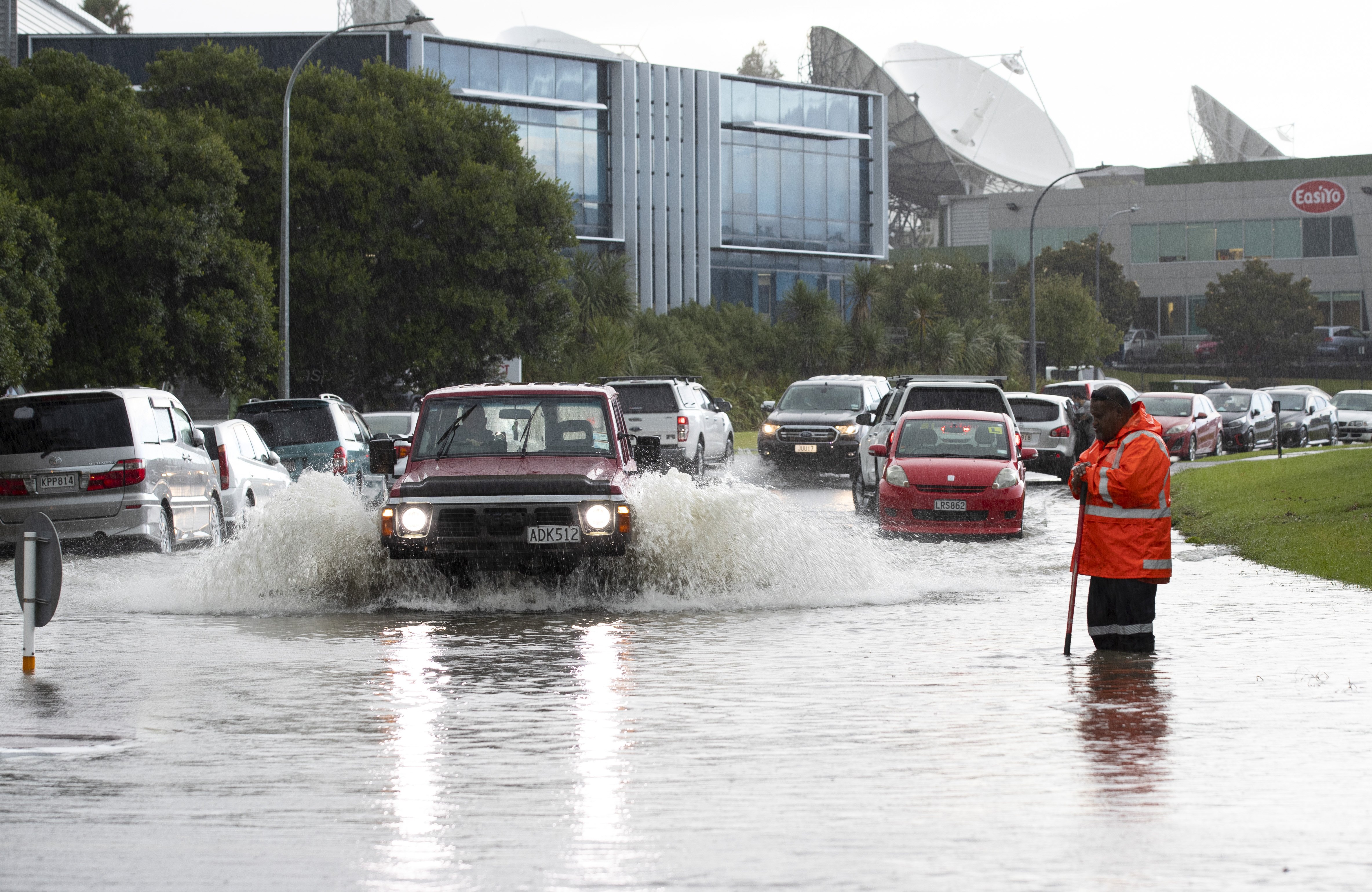 Cars attempt to negotiate flooding in Albany, Auckland after torrential rain  this week. PHOTO: NZME