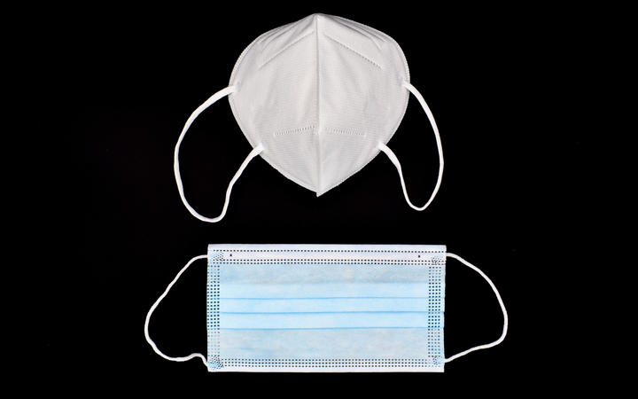 Disposable KN95 mask vs thin surgical mask. Photo: supplied via RNZ