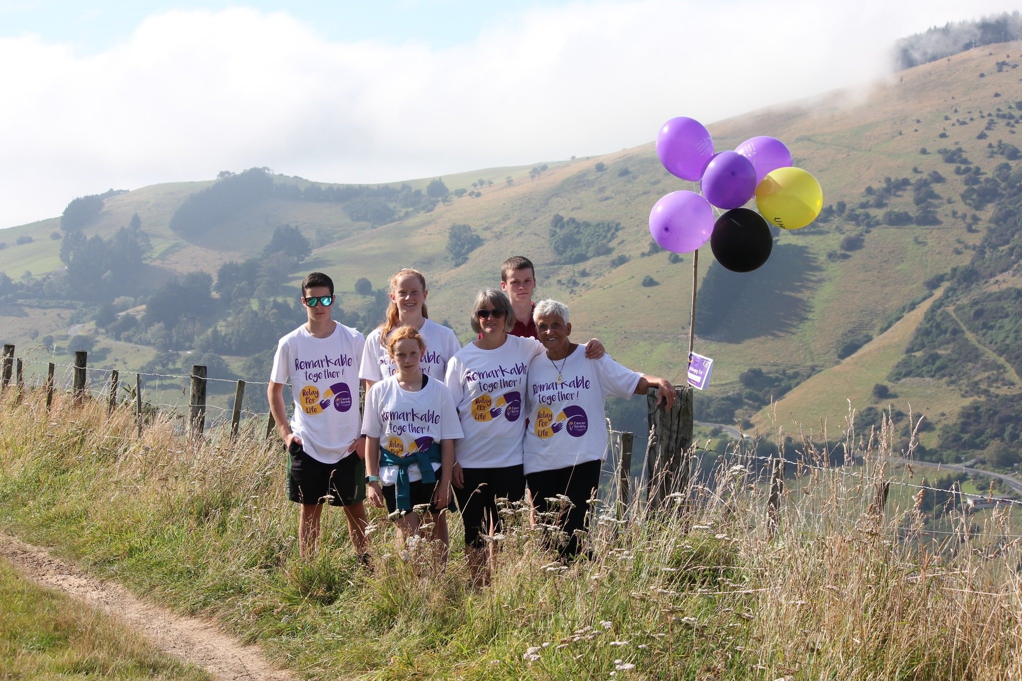Natalie Yeoman (far right) was supported by family members during her walk up Pine Hill, as part...