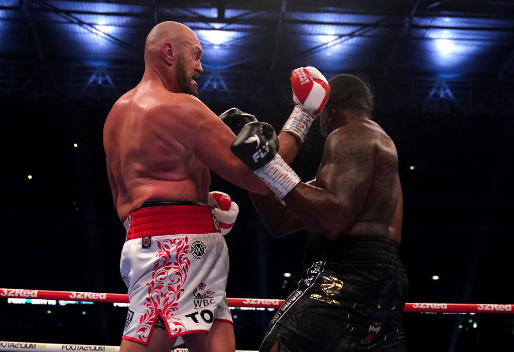 Tyson Fury (left) lands a punch to knock down Dillian Whyte during their clash at Wembley Stadium. Photo by Nick Potts/PA Images via Getty Images