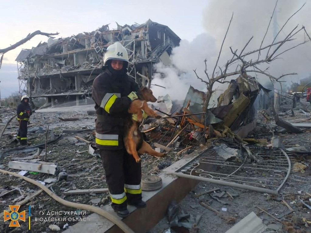 Emergency personnel work near a building damaged after a military strike, in Odesa, Ukraine....