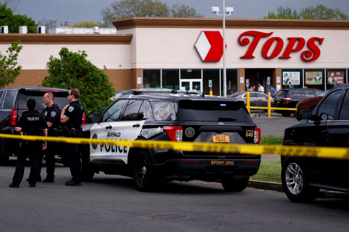 Police officers secure the scene after the shooting at TOPS supermarket in Buffalo, New York....