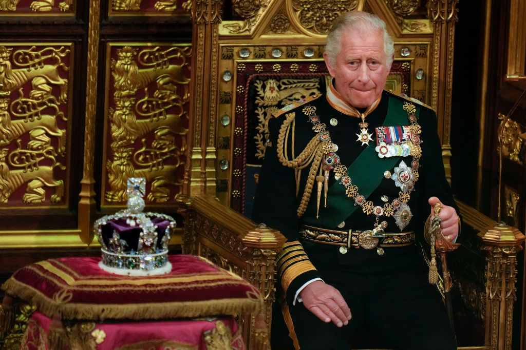 Prince Charles sits next to the Queen's crown in the House of Lords Chamber during the State...