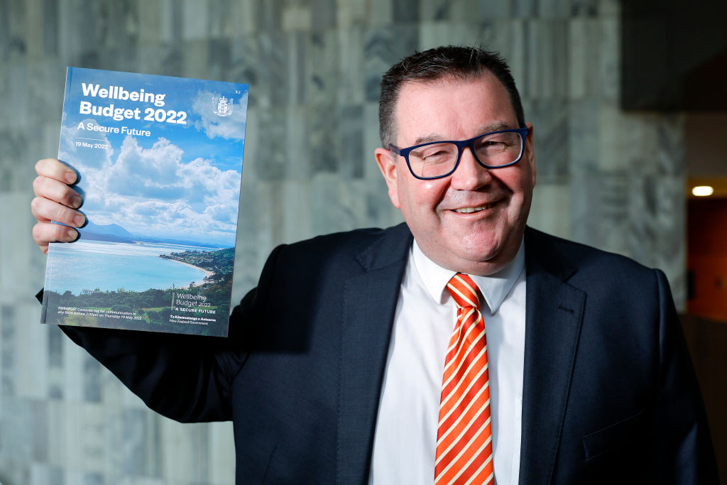 Finance Minister Grant Robertson poses with a copy of the Wellbeing Budget 2022 during a photocall at Parliament. Photo: Getty