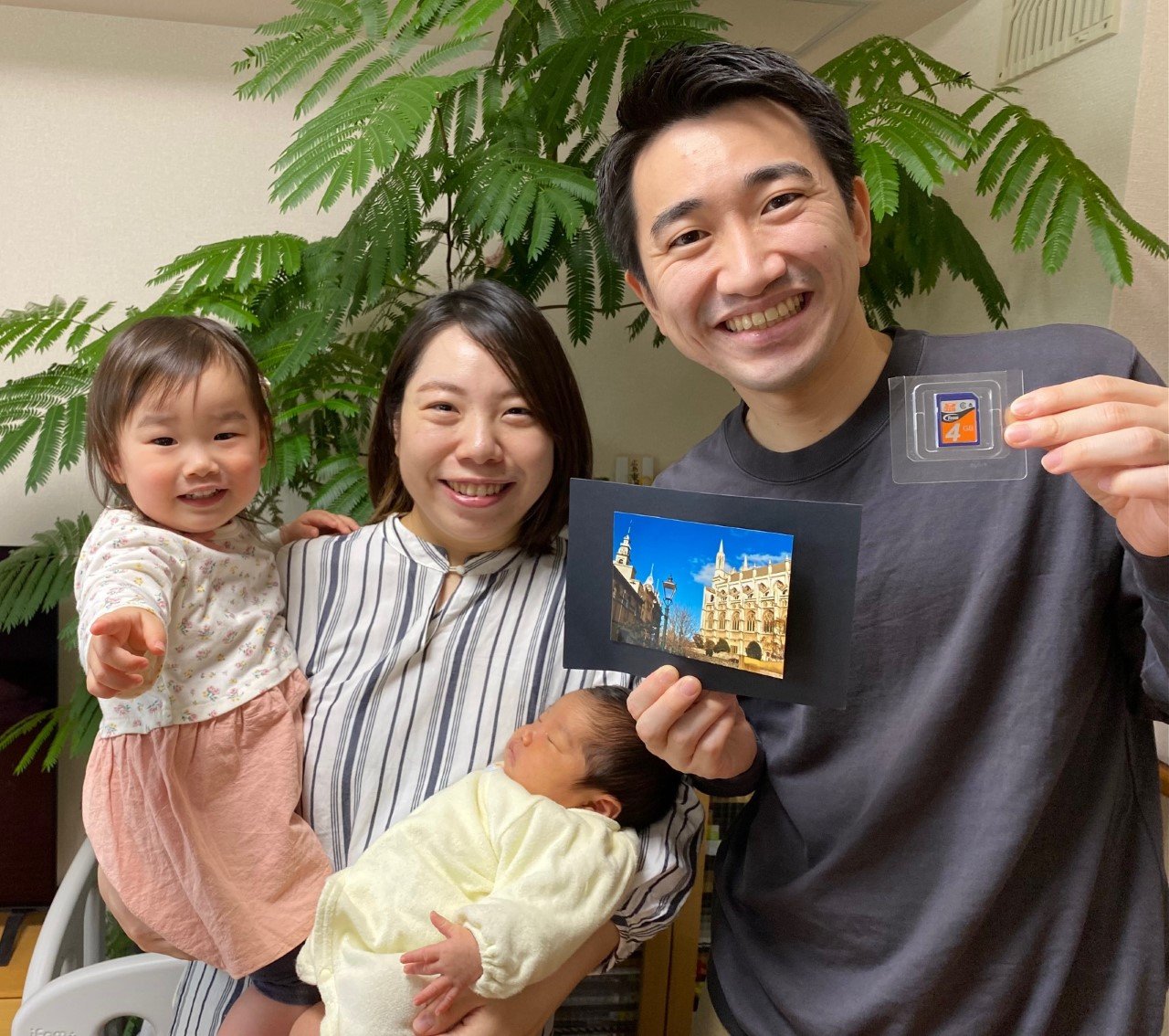 Akina Tominaga holds her daughters Itoha (3 weeks) and Fumika (2), while husband Shunya Tominaga...