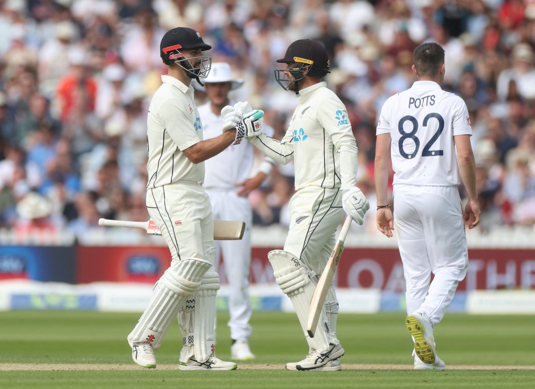 Tom Blundell (R) celebrates with Daryl Mitchell after reaching his half century. Photo: Action...