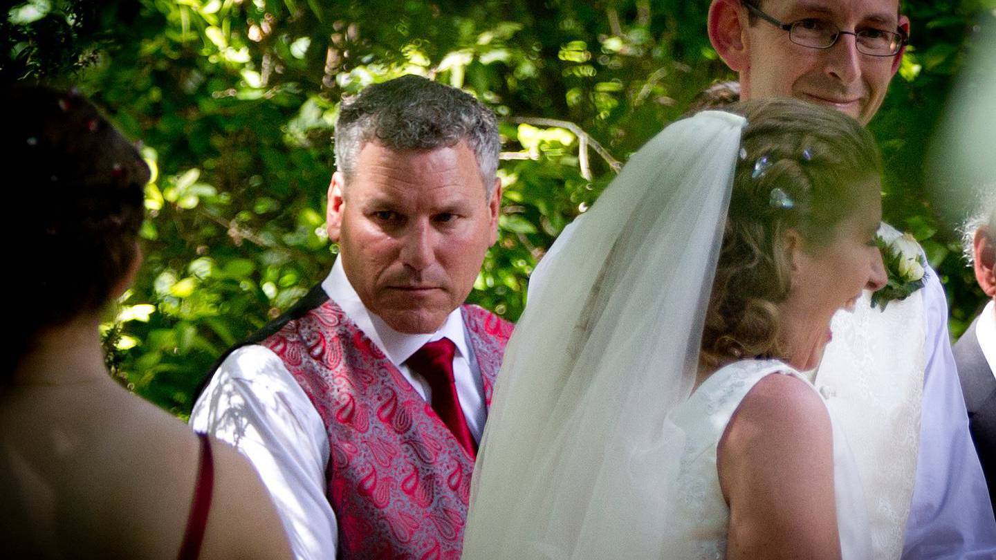 Groomsman Paul Wilson, left, with newly married couple David Bain, right, and Liz Davies, centre,...