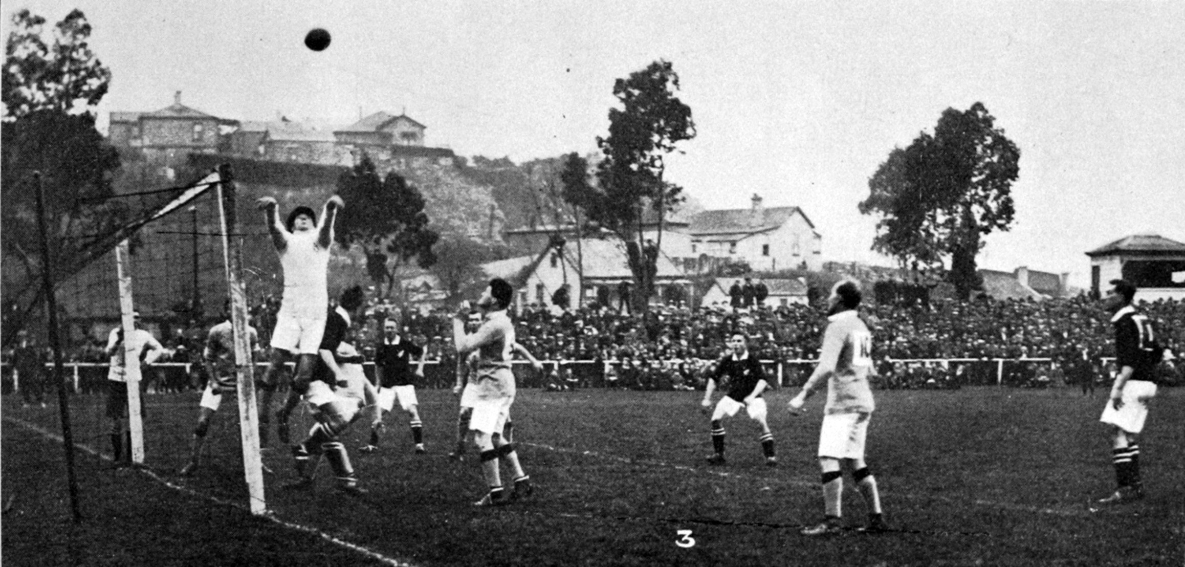 New Zealand goalkeeper Reg Craxton makes an aerial leap to keep the Australians at bay at...