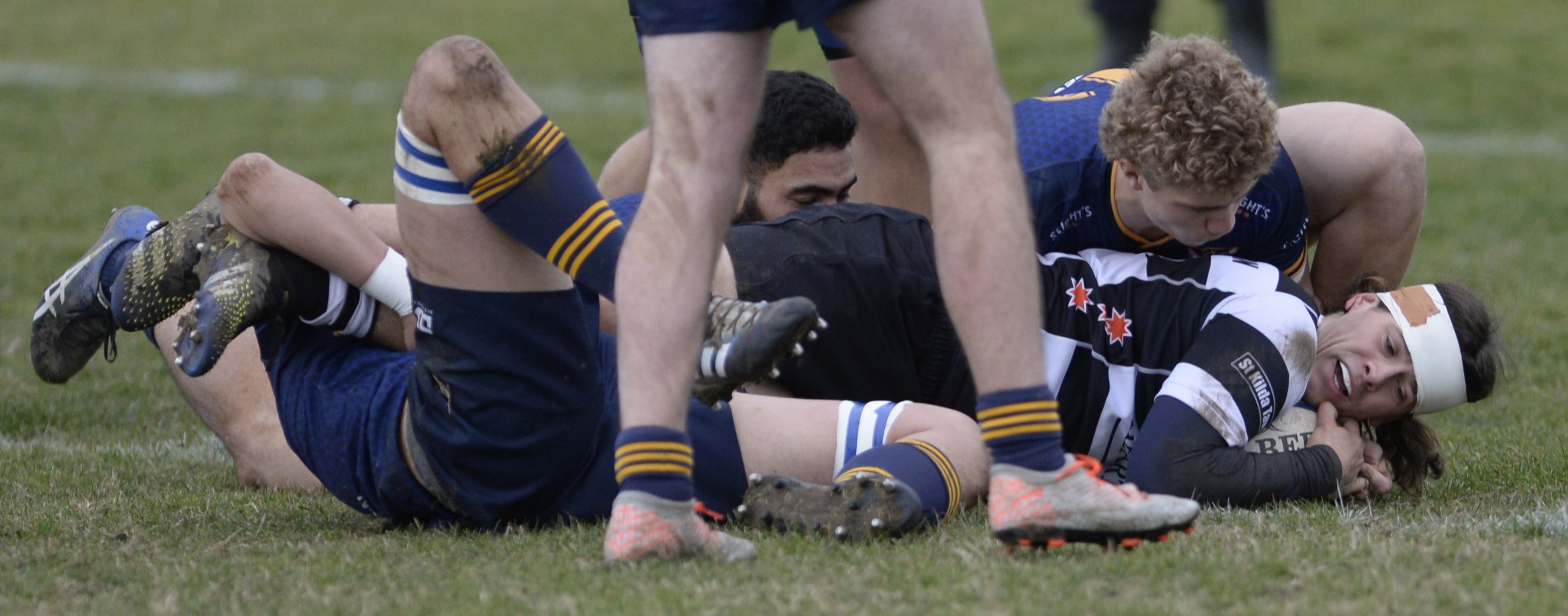 Southern second five Henri Mitchell-Collie dots down in a tangle of Dunedin players. PHOTOS:...