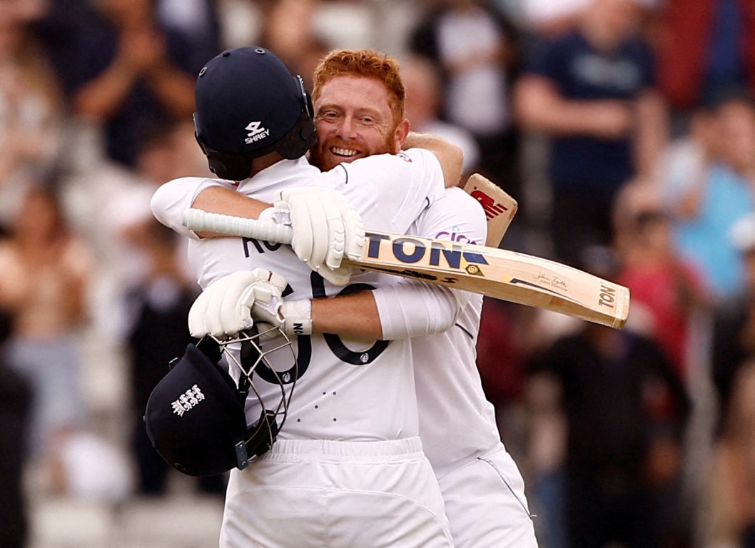 England's Jonny Bairstow celebrates reaching his century with teammate Joe Root. Photo: Reuters
