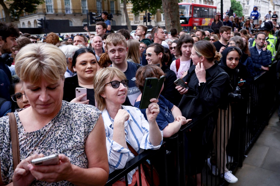 People gather outside Downing Street to listen to Boris Johnson make his statement. Photo: Reuters