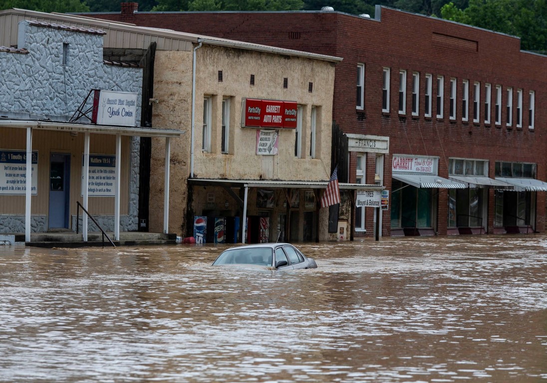 A car is caught in floodwaters along Right Beaver Creek in Garrett, Kentucky. Photo: Pat McDonogh...