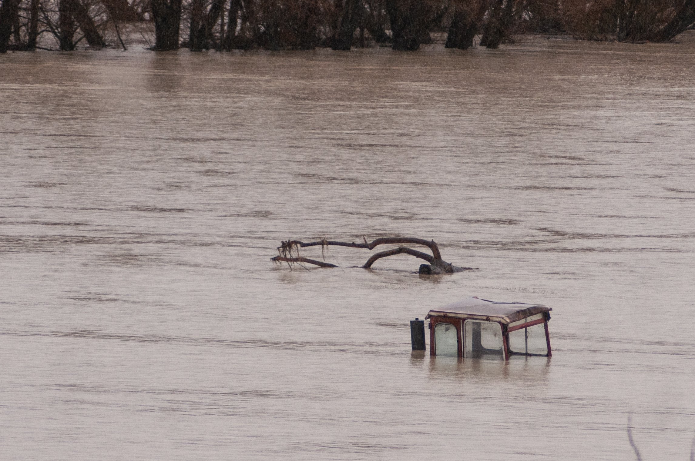 A tractor lies submerged in floodwater at Omakau. PHOTO: SHANNON THOMSON