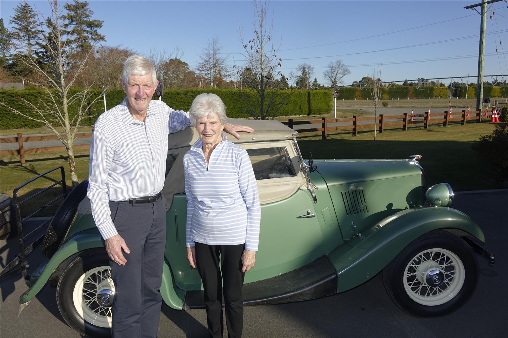 Councillor Stuart Wilson and wife Betty with his first car, a Morris Eight Sport. Photo: Supplied