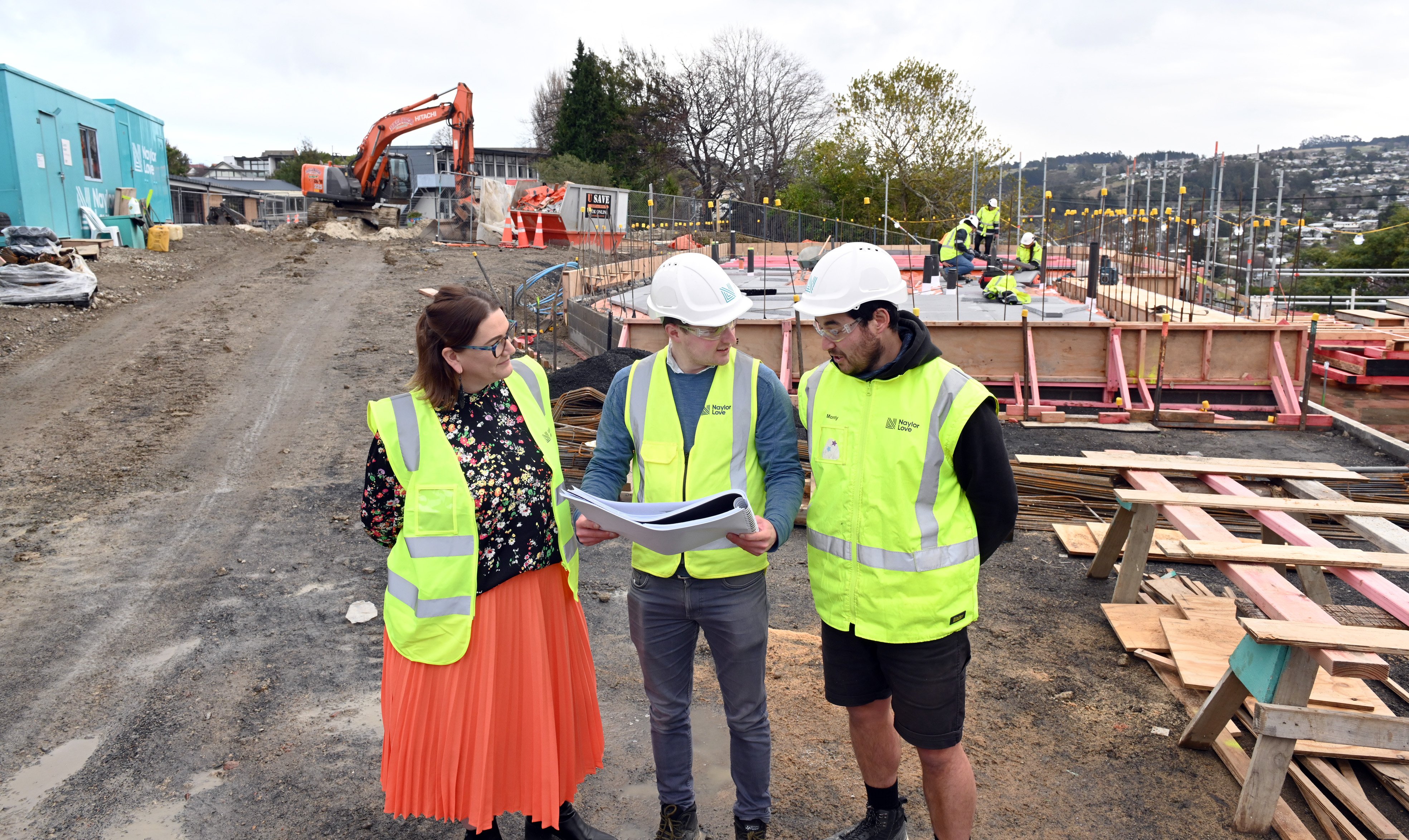 Looking at site plans in front of Kaikorai Primary School redevelopment construction work...
