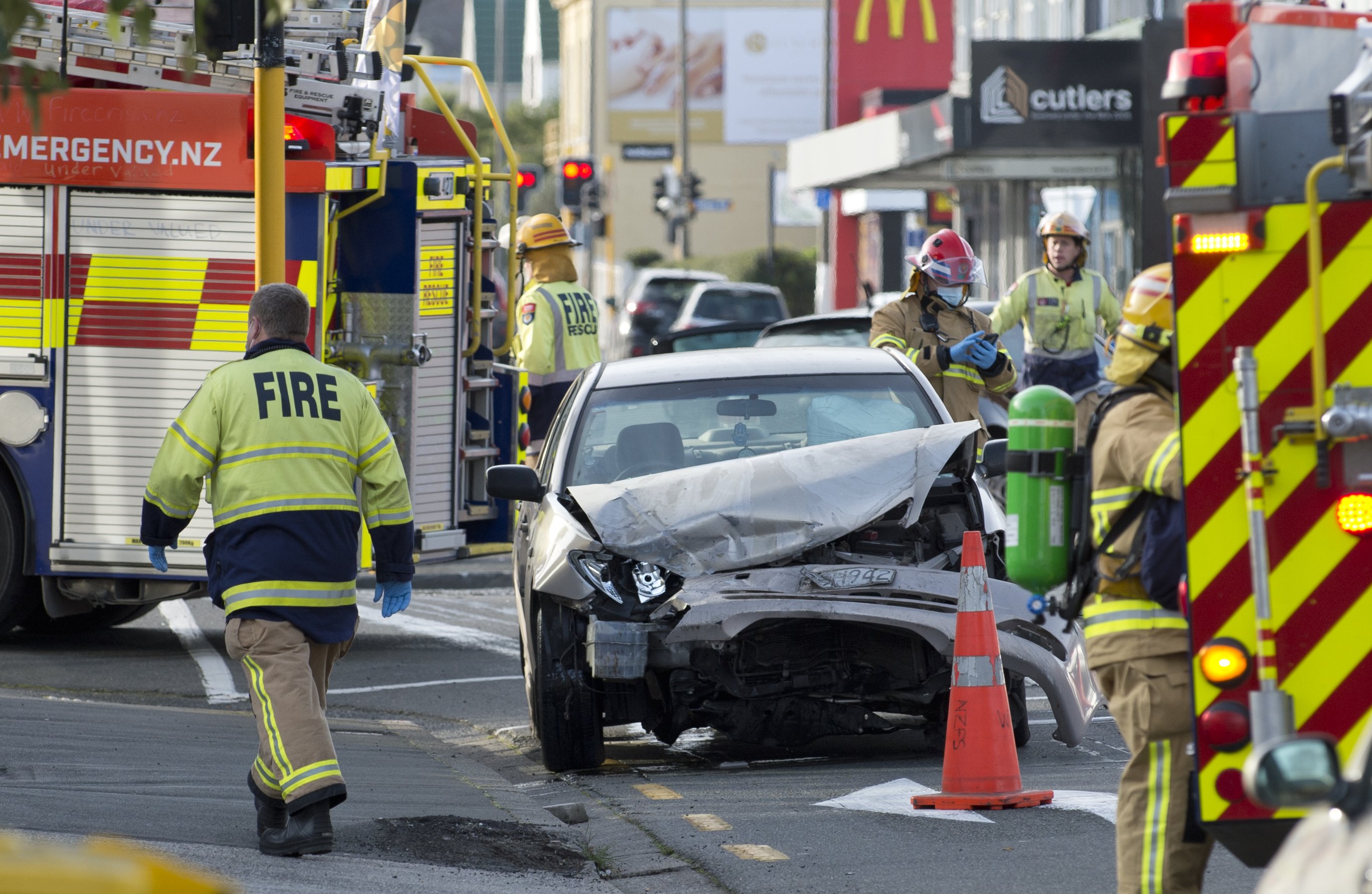 Firefighters at the scene of the crash, at the intersection of Dundas and Great King Sts. Photo:...
