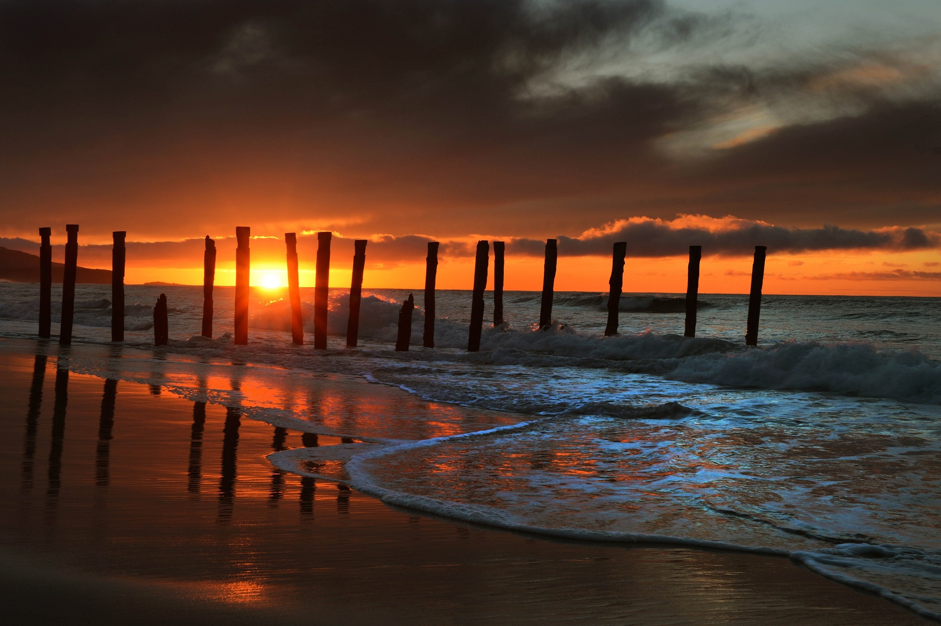 A line of poles stands tall at St Clair Beach in Dunedin during a September sunrise in 2012. — ...