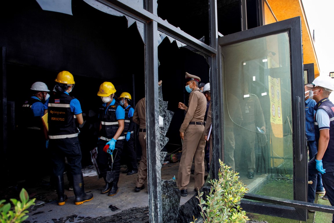 Forensic and police officers at the scene following the fire. Photo: Reuters