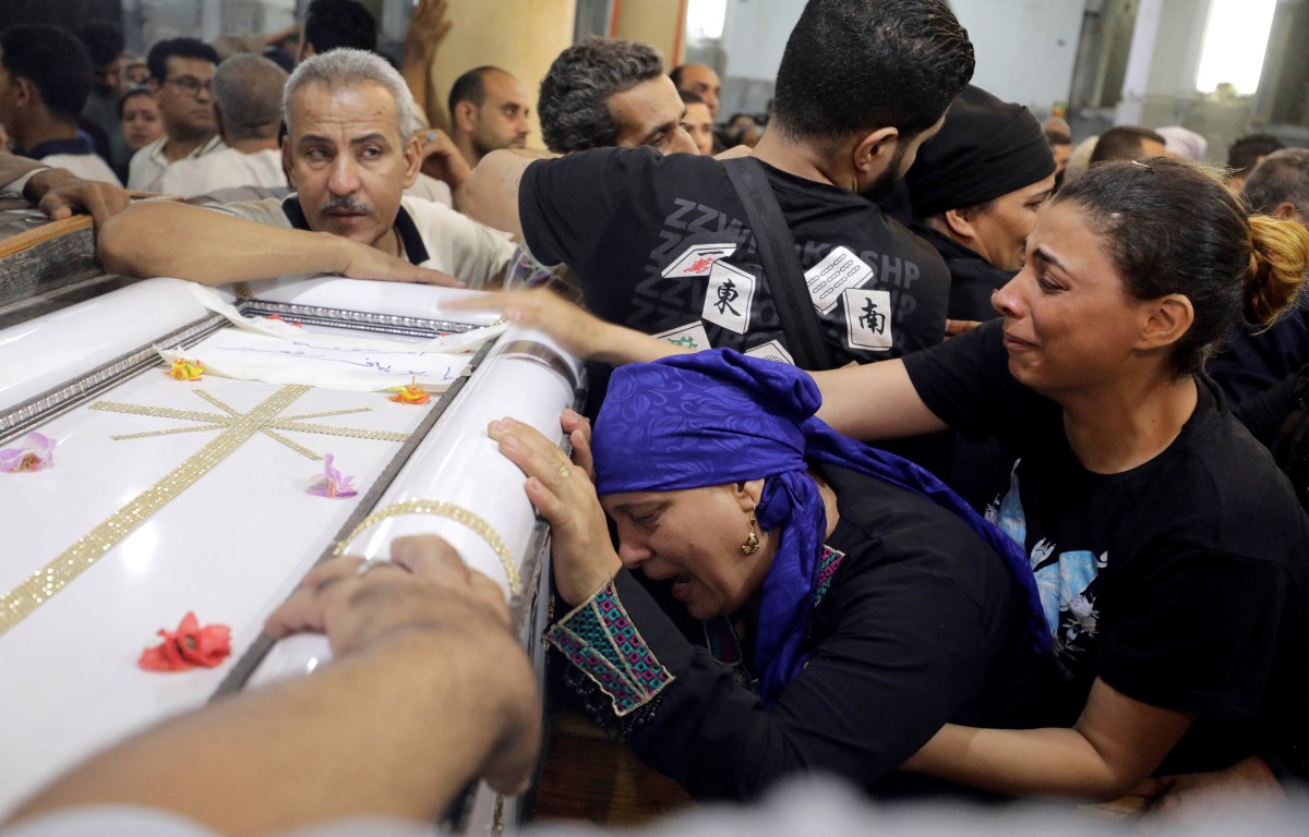 People grieve at a funeral for victims of the fire, in the Church of the Blessed Virgin Mary at...