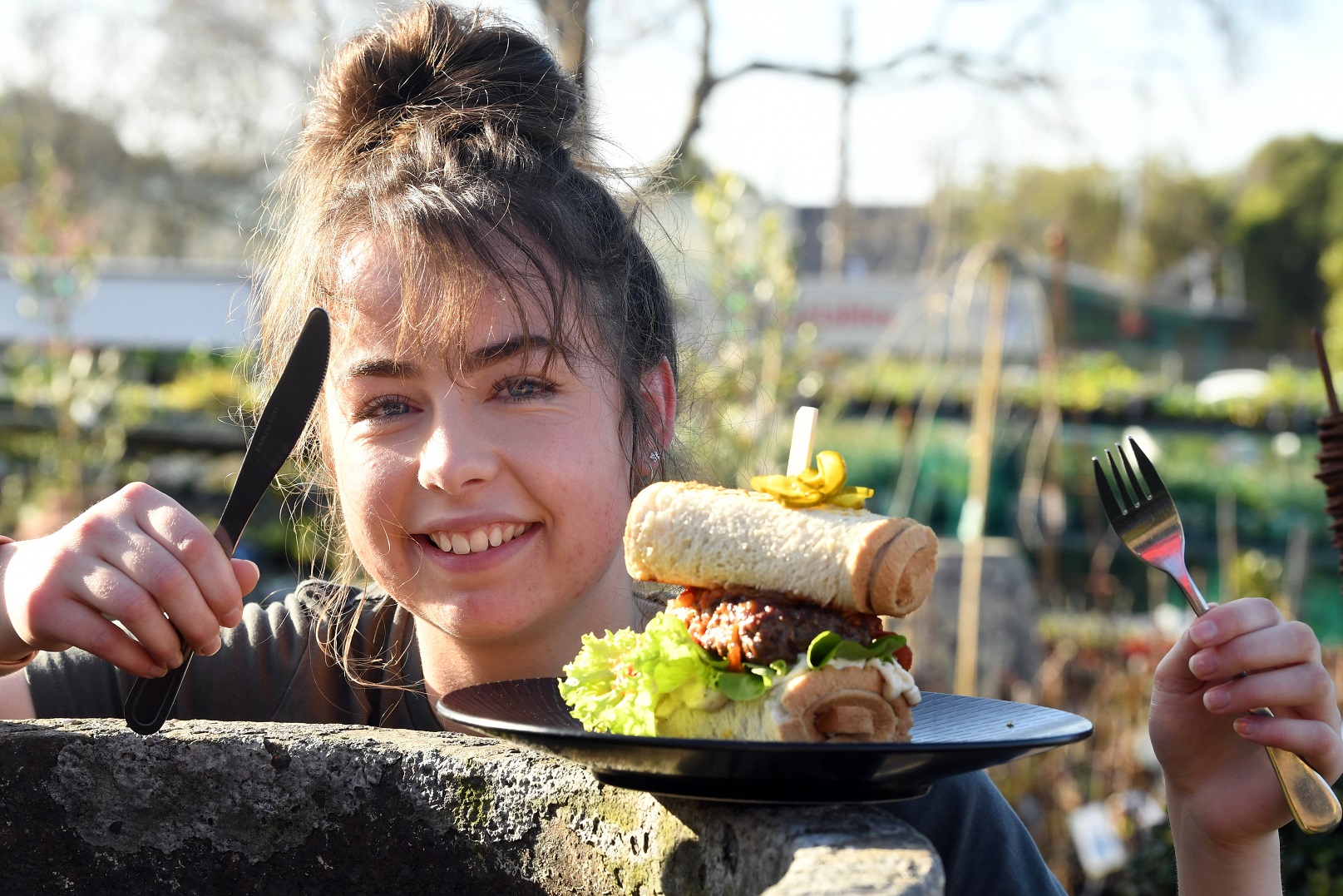 Blueskin Nurseries & Cafe barista Kaysha Homan holds a knife and fork, ready to tackle the new...