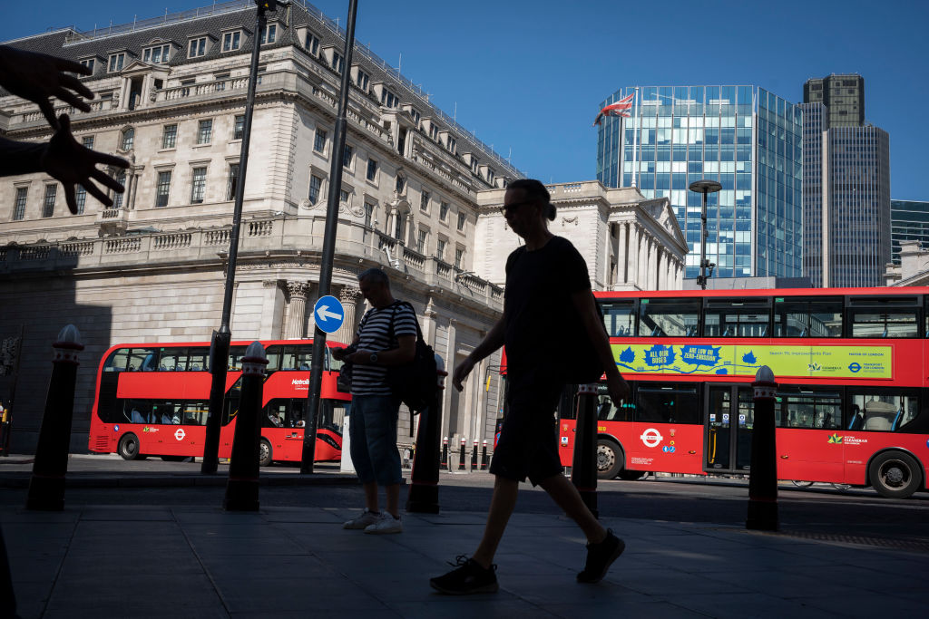 People walk near the Bank of England in the City of London, the capital's financial district. Photo: Getty