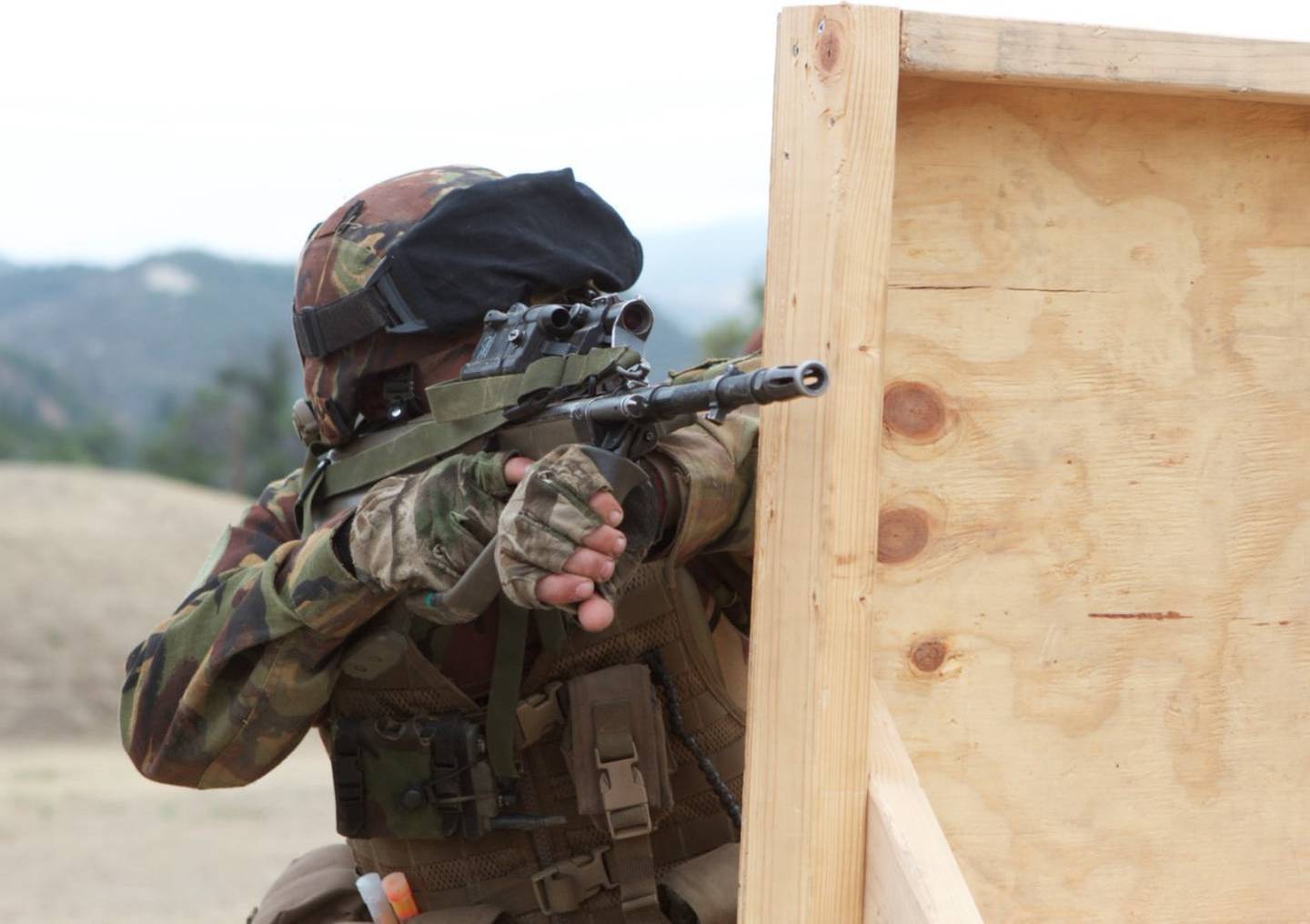 Private Dominic Abelen kneels behind a barricade while engaging targets at Range 218, Marine...
