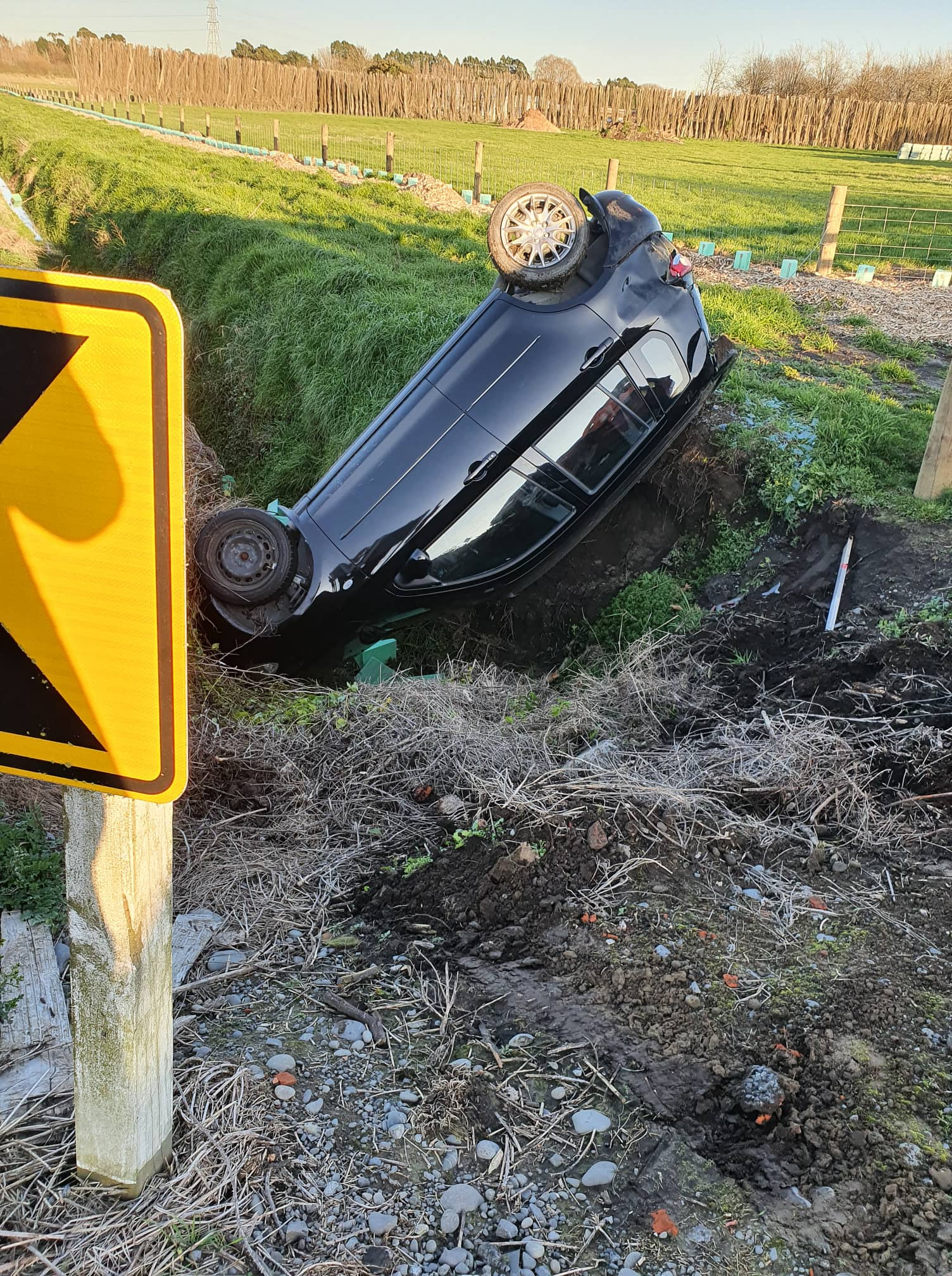 The driver of this vehicle was helped out of his car by a passing motorist. Photo: Supplied