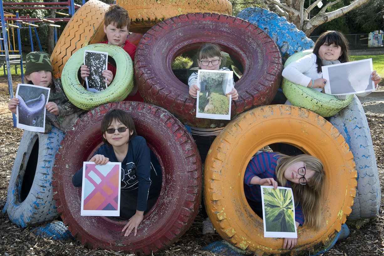 Displaying their favourite photographs taken as part of a St Leonards School project are pupils ...