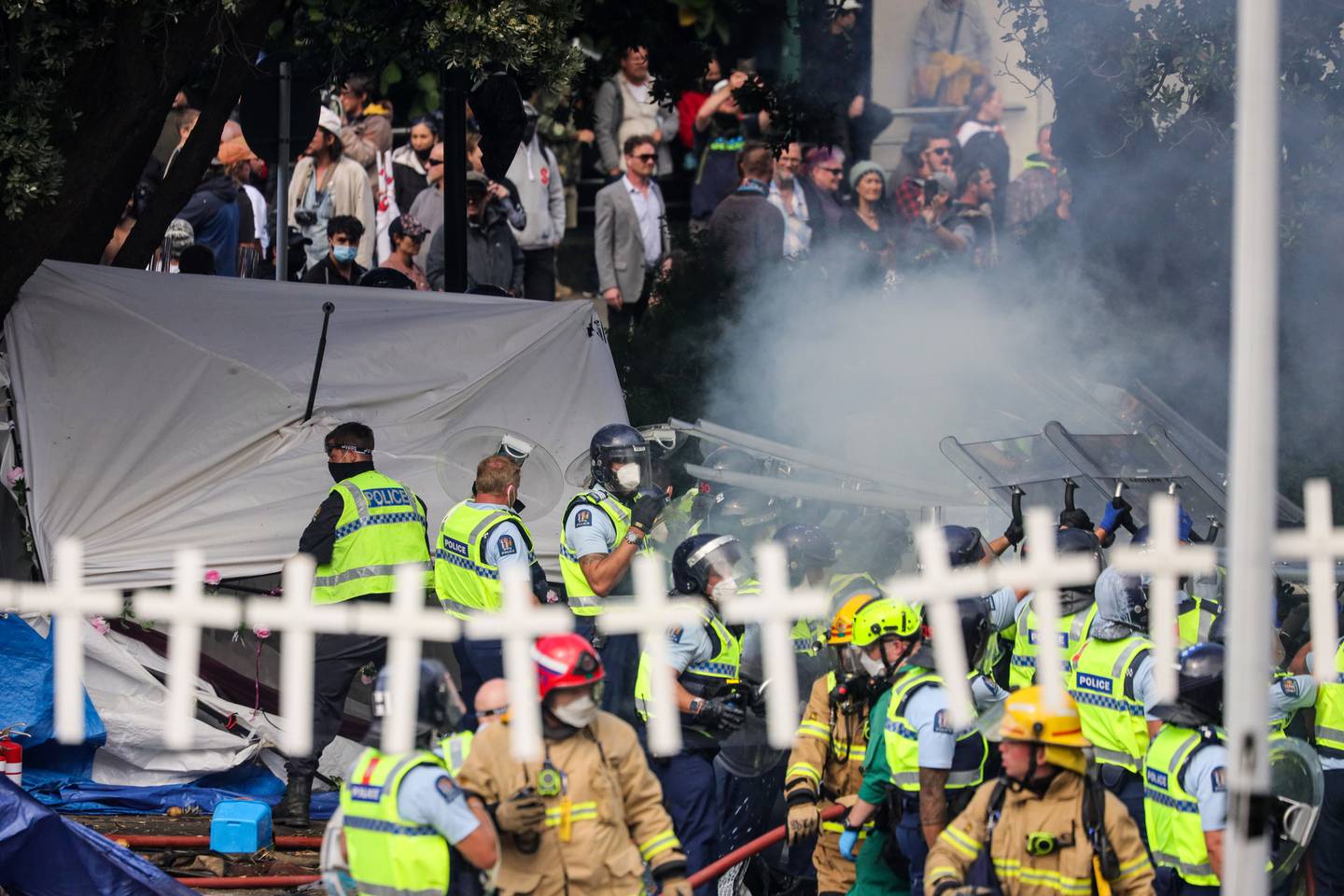 Police and firefighters clear protesters as tents burned on Parliament's lawns. Photo: Mike Scott